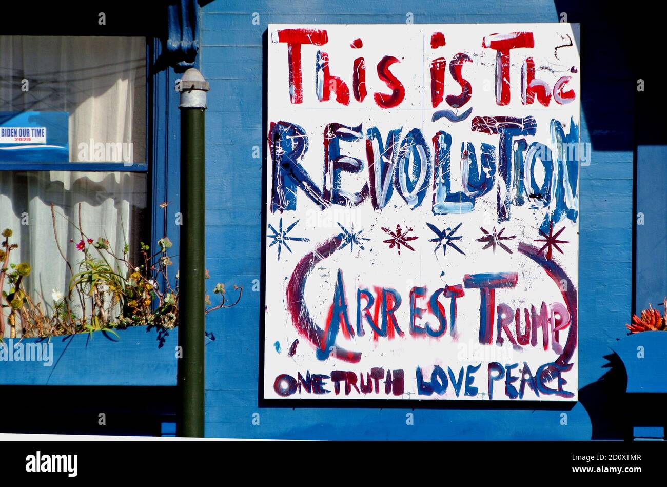 protest sign in mission district of san francisco declaring this is the revolution and arrest Trump Stock Photo