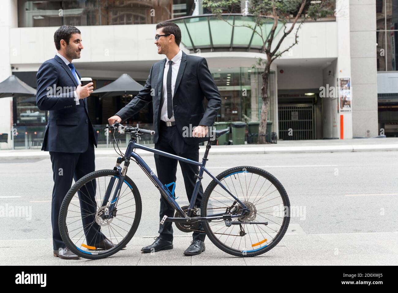 Two businessmen having walk Stock Photo - Alamy