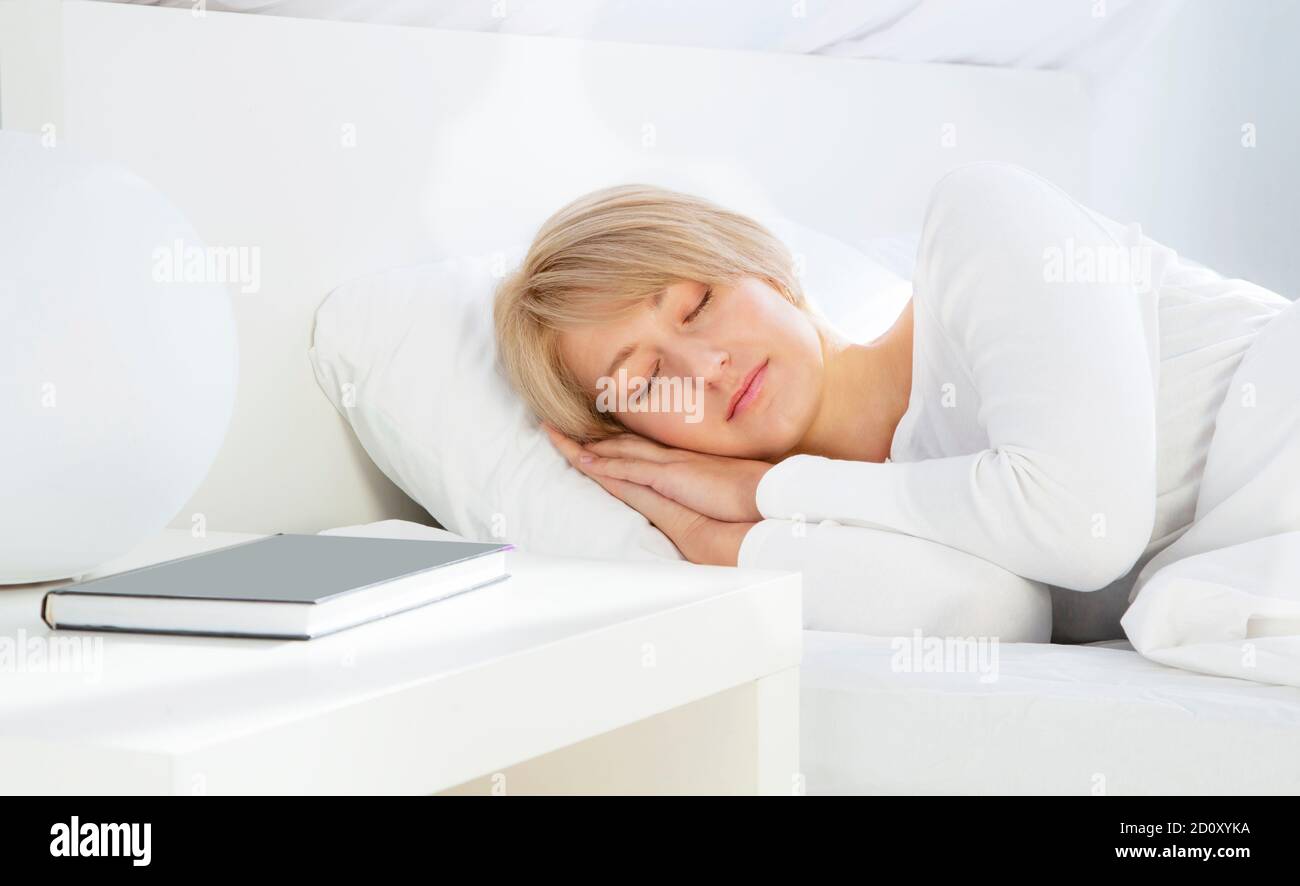 Beautiful woman sleeping in white bed Stock Photo - Alamy