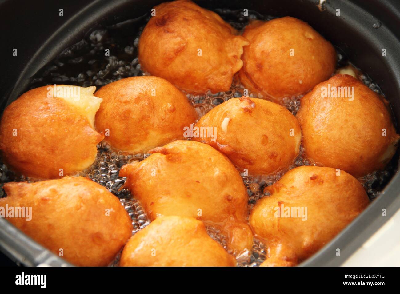 fresh donuts deepfried in the deep fryer Stock Photo Alamy