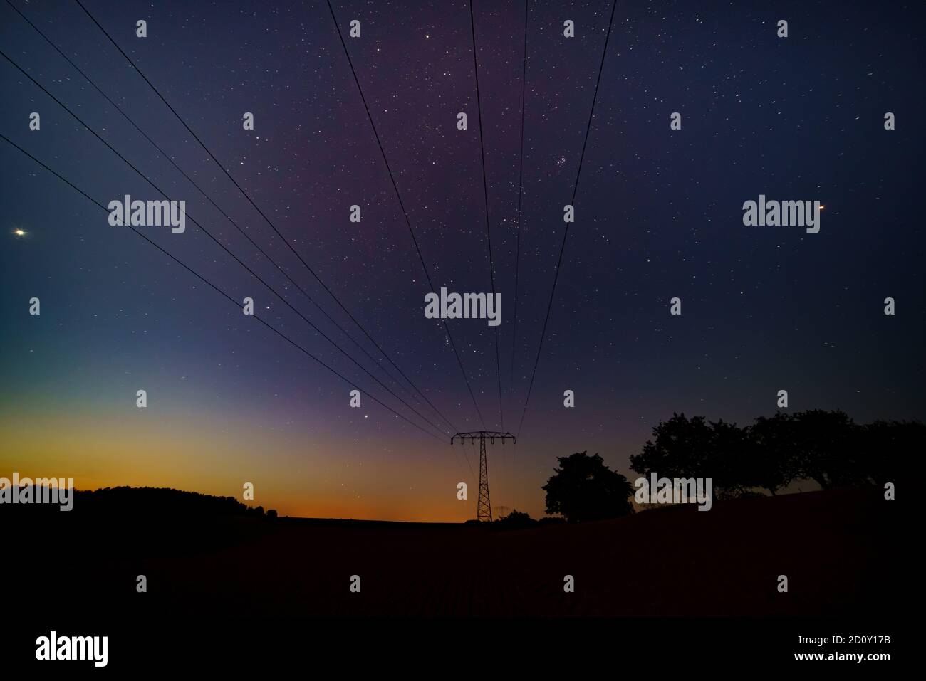 Night landscape with power lines on the starry sky Stock Photo - Alamy
