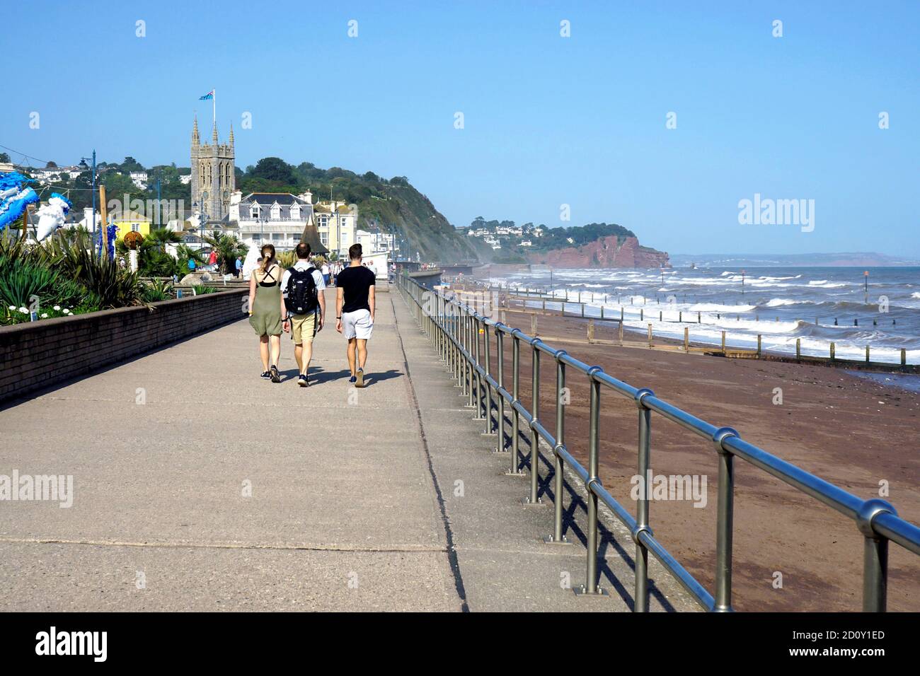 Teignmouth, Devon, UK. September 17, 2020.  Holidaymakers walking the promenade on a windy day at high tide at Teignmouth in Devon, UK. Stock Photo