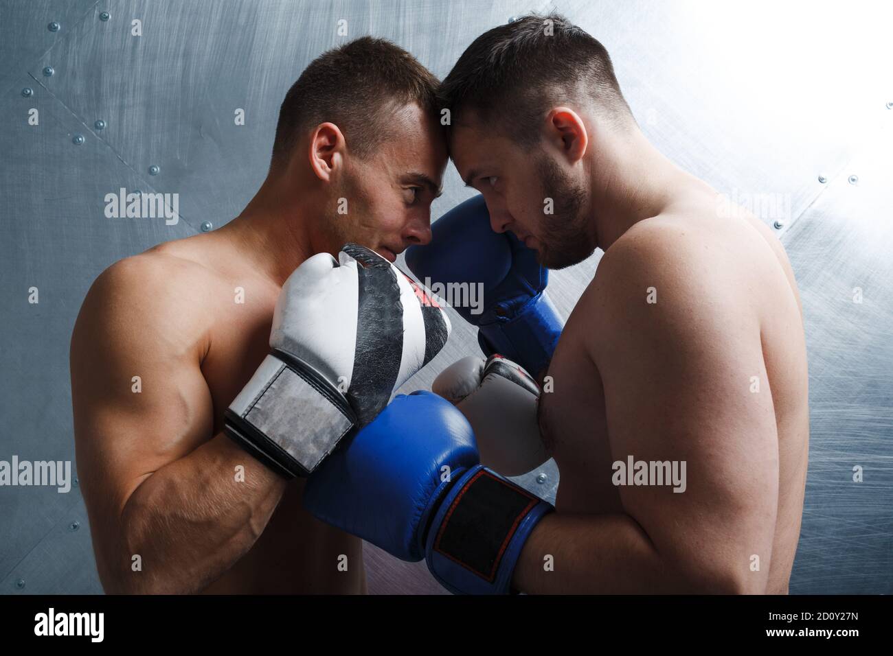 Two men boxers fighting muay thai boxing. Face to face posing. Stock Photo