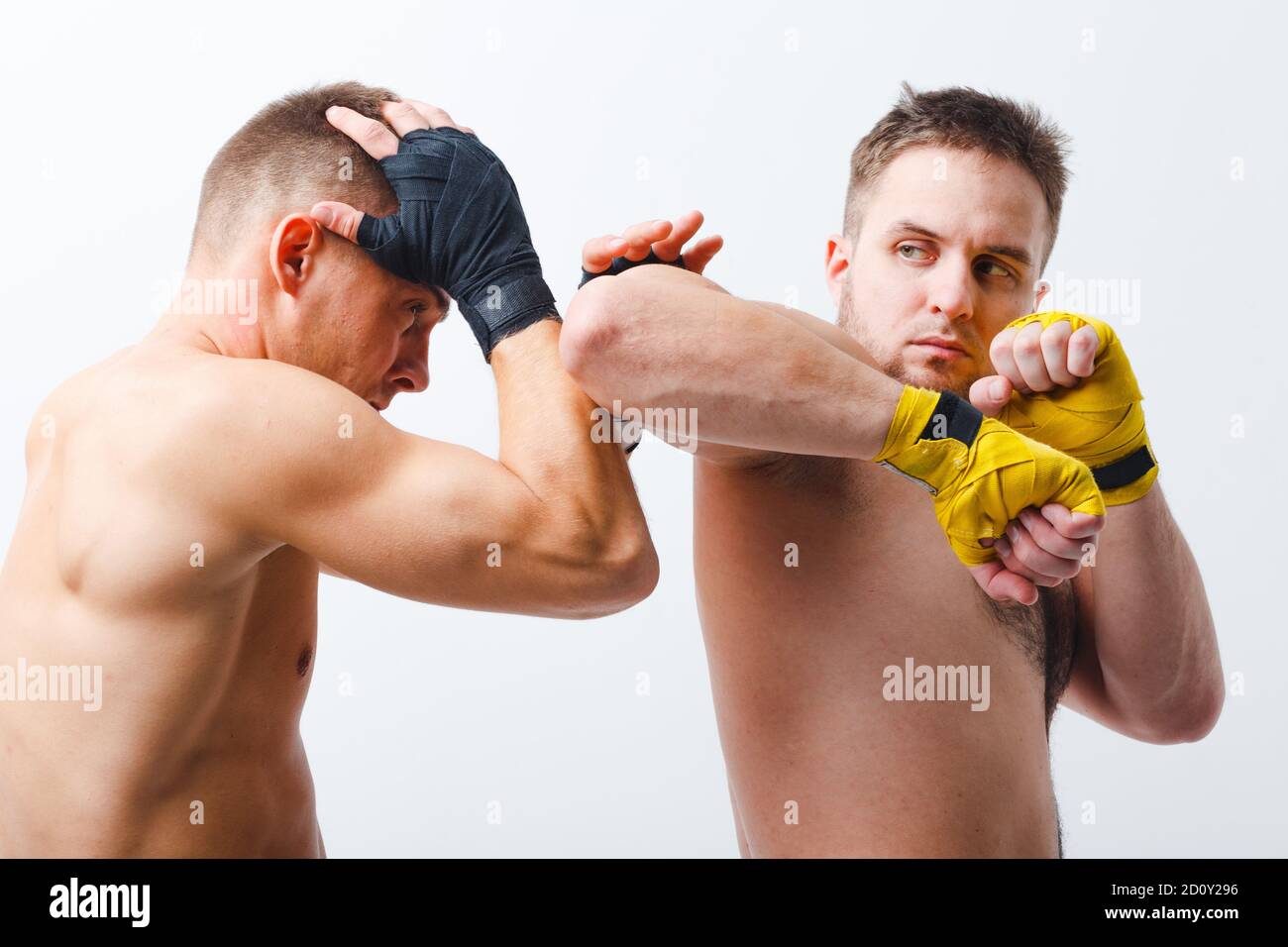 Two men boxers fighting muay thai boxing elbow white background Stock
