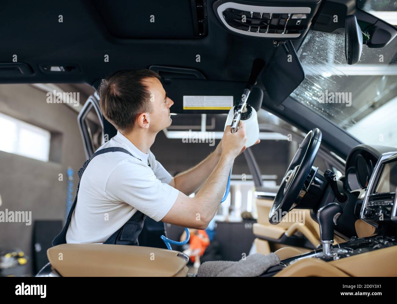 Worker watering car interior, detailing Stock Photo Alamy