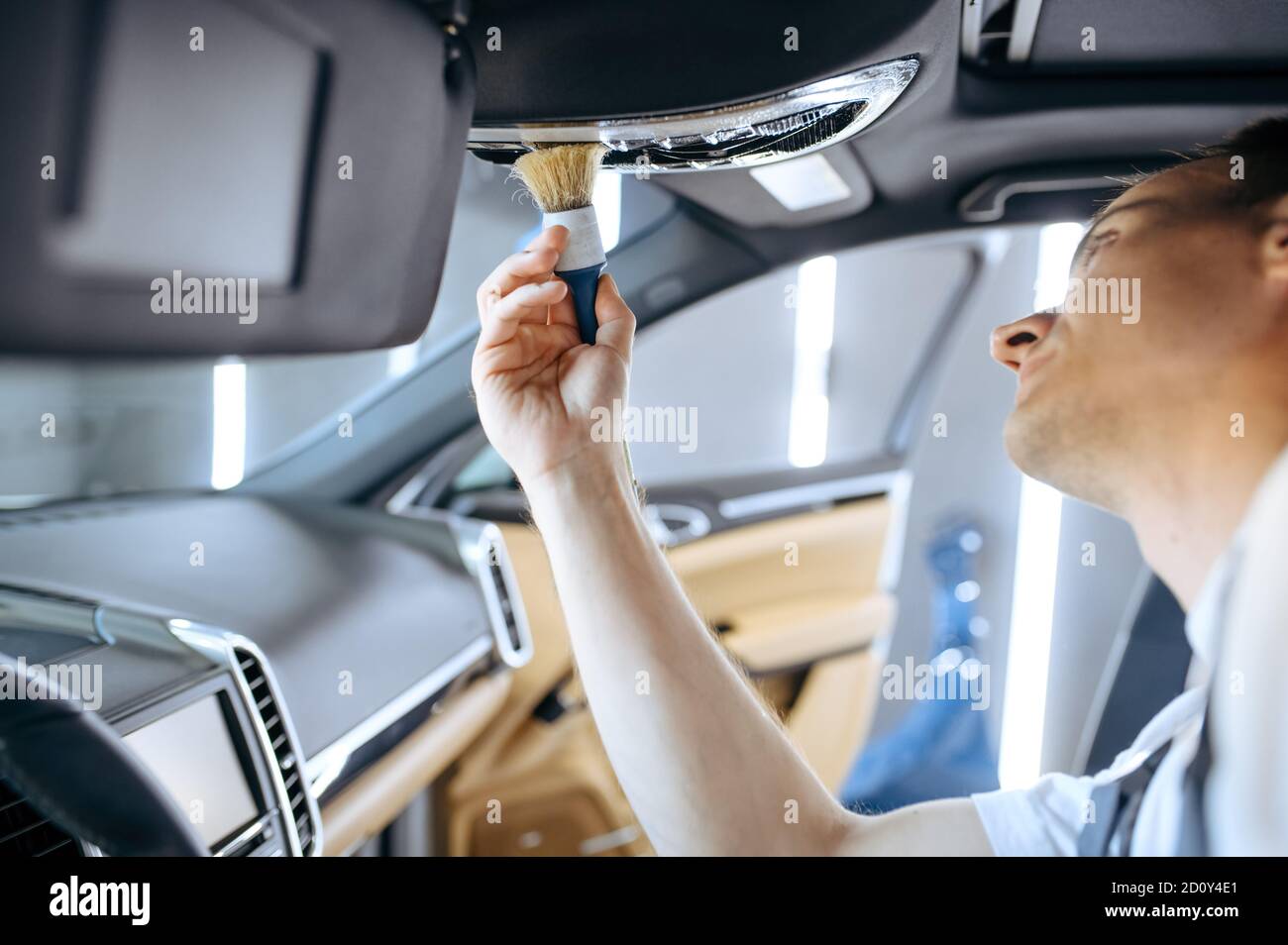 Worker wipes car interior, detailing Stock Photo Alamy