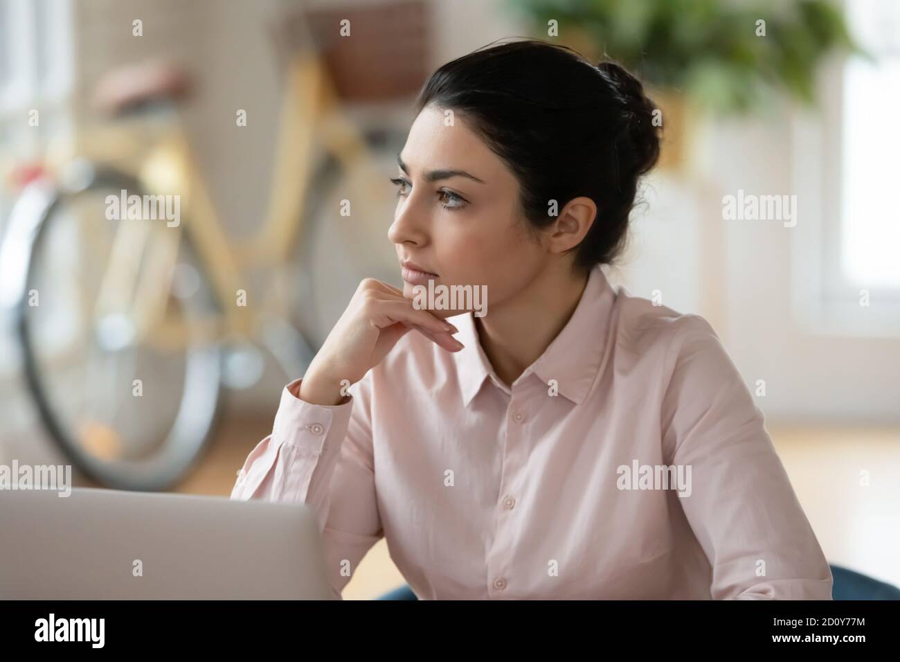 Pensive young indian woman look in distance thinking Stock Photo - Alamy