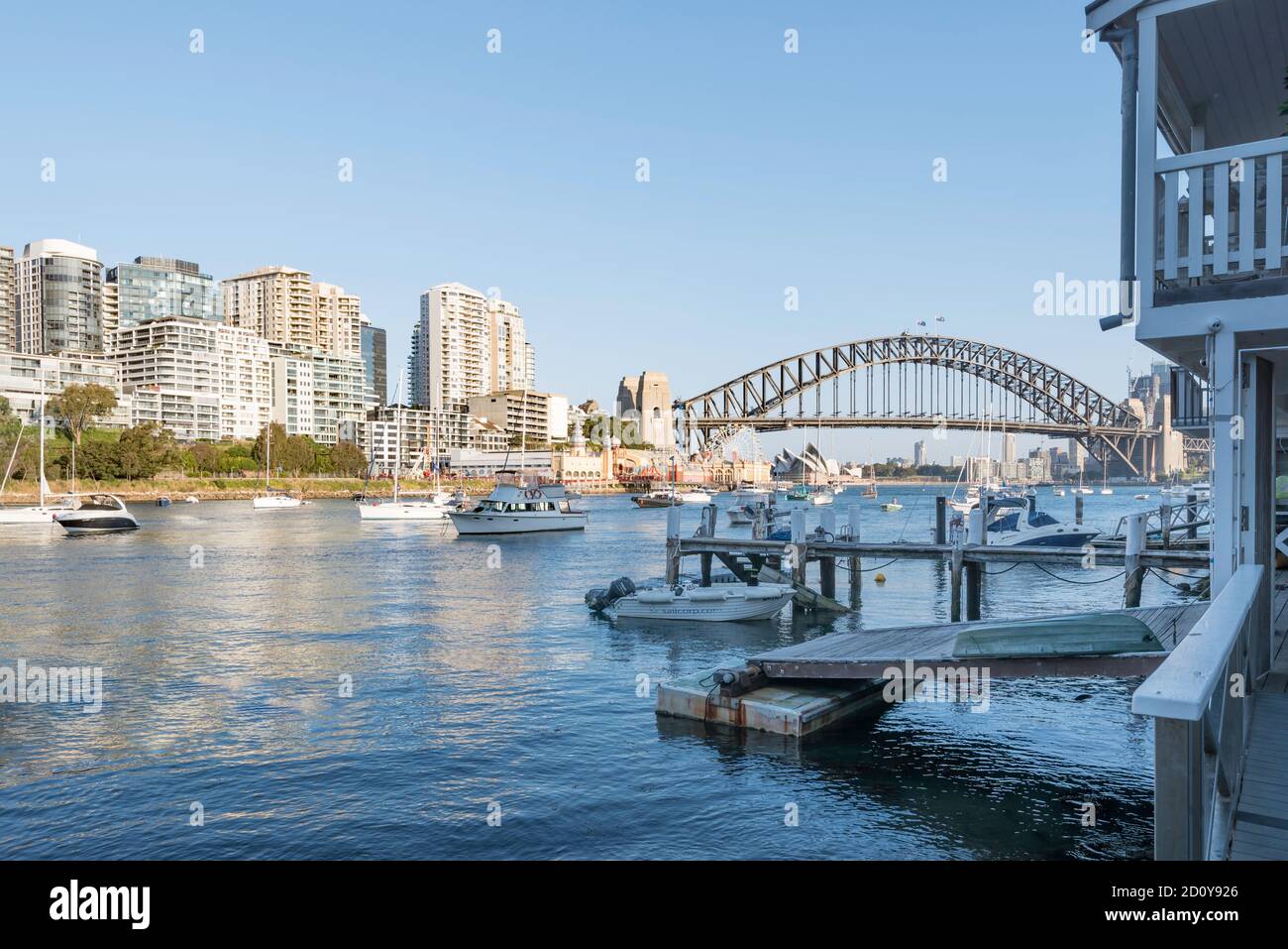 Looking across Lavender Bay in Sydney Harbour to apartments on Milsons Point and the Sydney Harbour Bridge in Australia Stock Photo