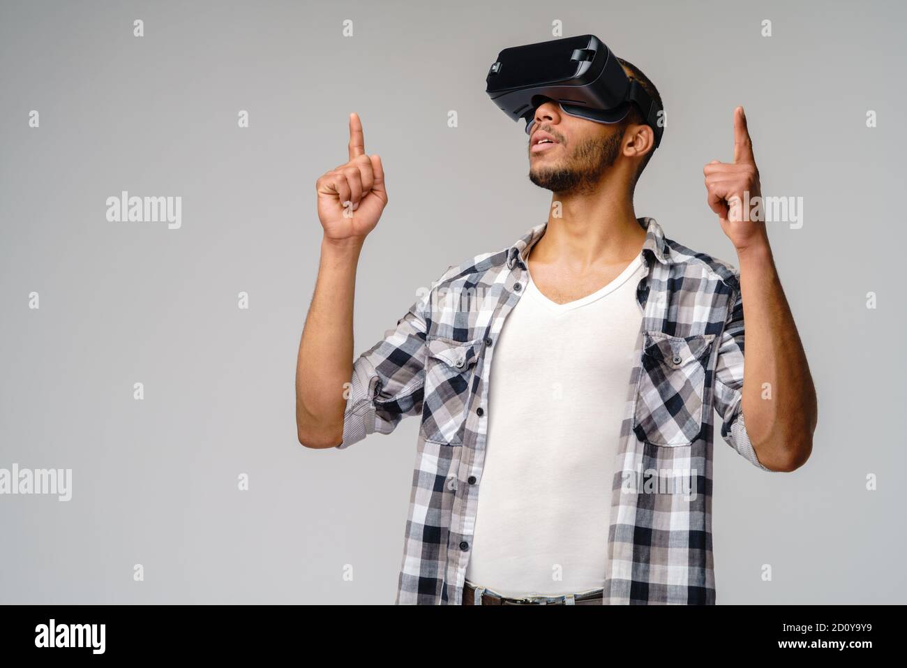 Young African-American young man wearing vr virtual reality headset ...