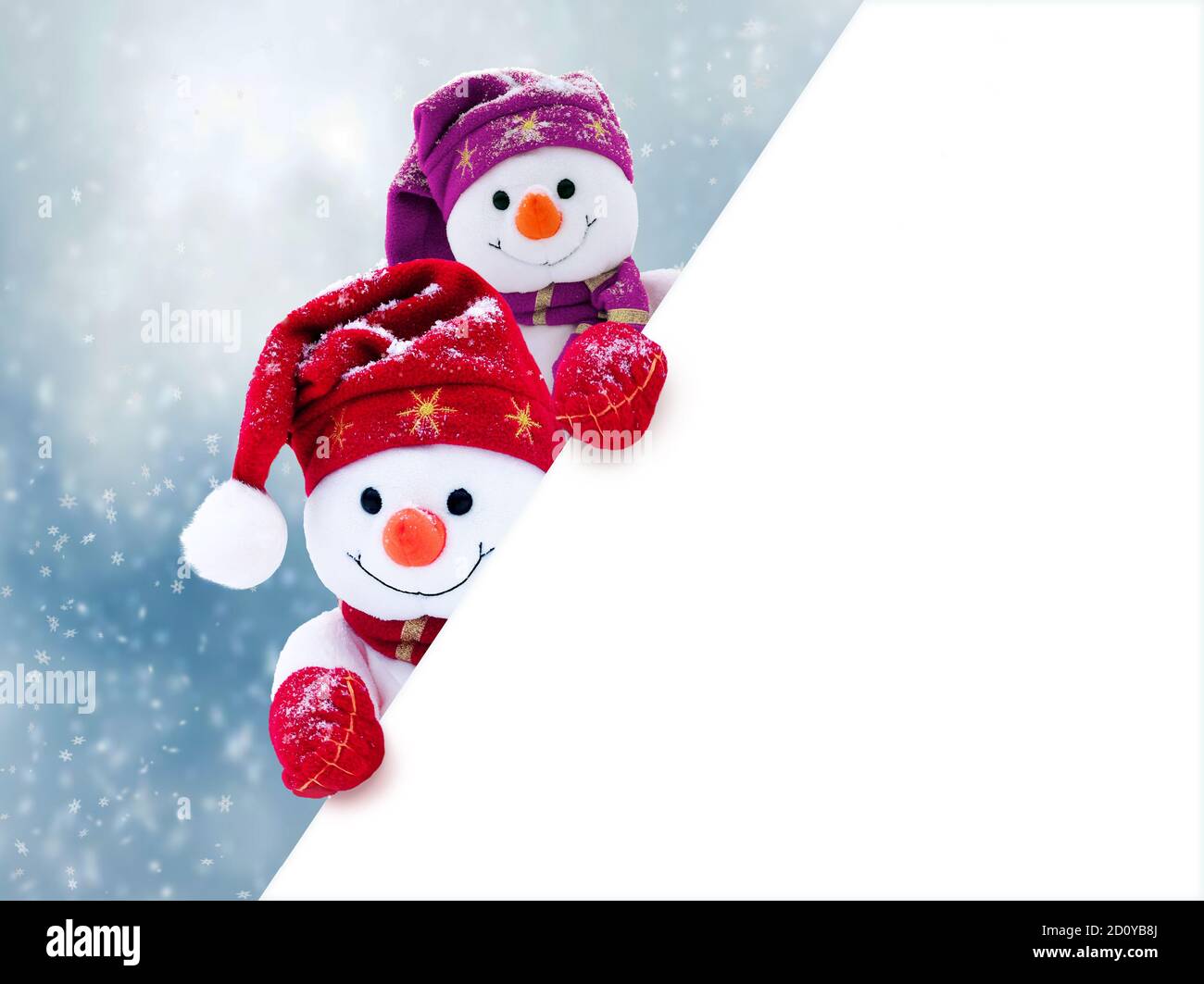 Two little snowmen the girl and the boy in caps and scarfs on snow in ...