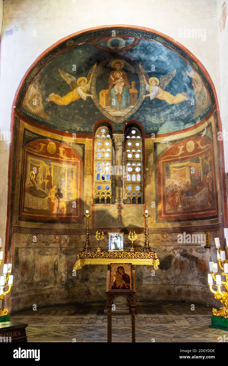 Left apse, dedicated to Our Lady of Loreto, with altar and 19th century frescoes damaged by rising damp, at the Santa Maria in Cosmedin church, Rome. Stock Photo