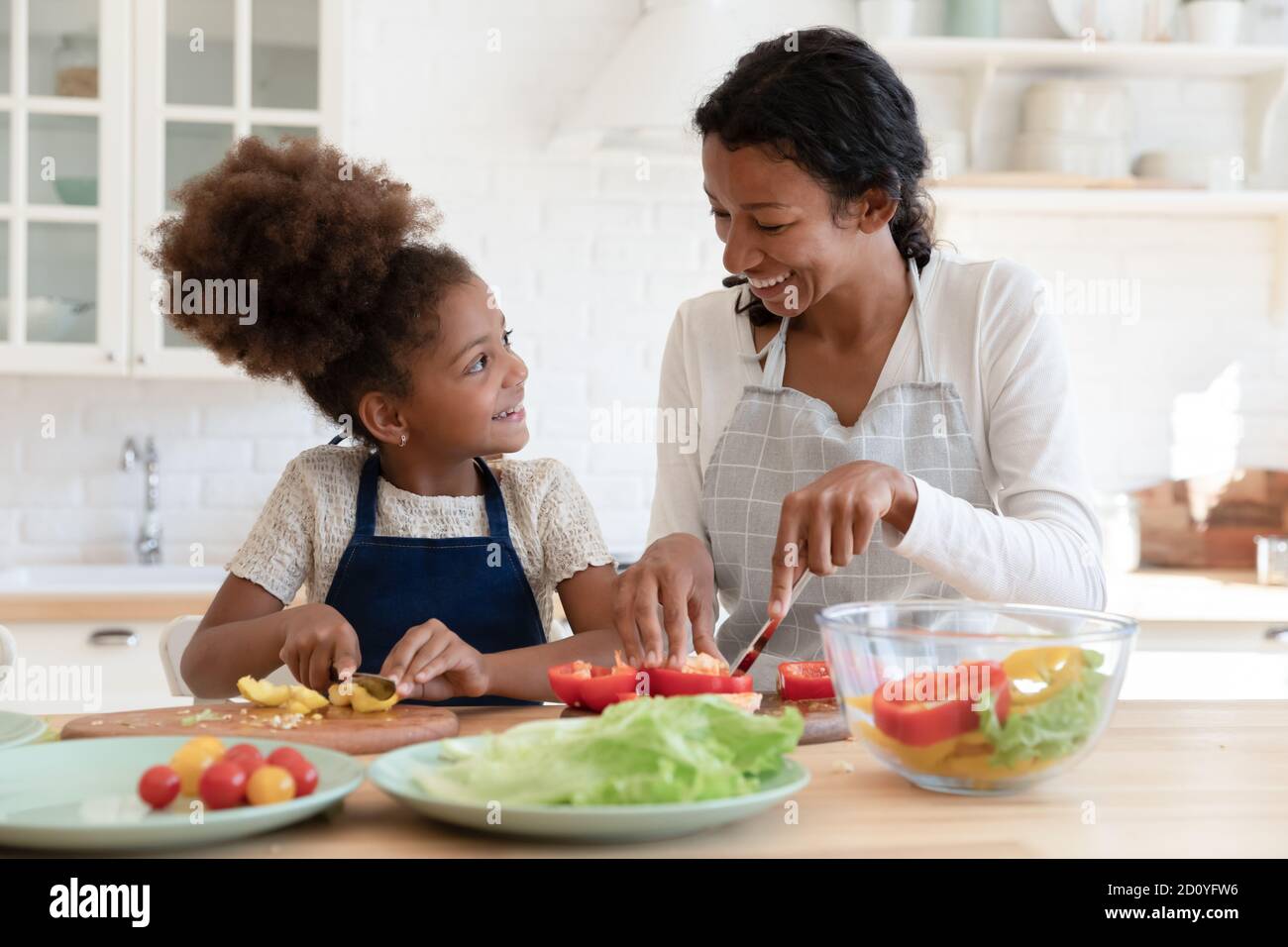 Happy afro girl cooking with mum in kitchen Stock Photo Alamy