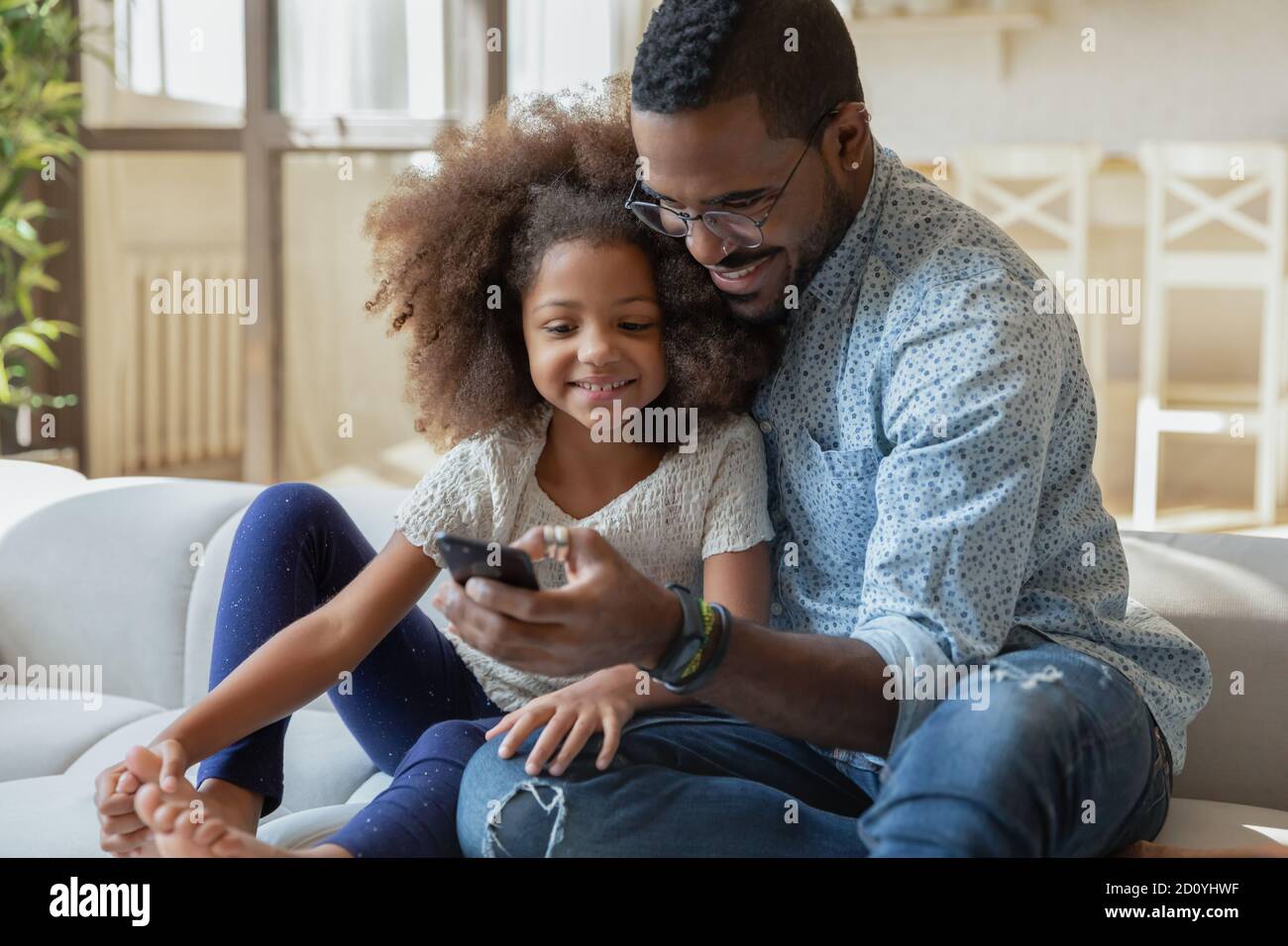 Happy young african ethnicity dad recording funny video with kid Stock  Photo - Alamy
