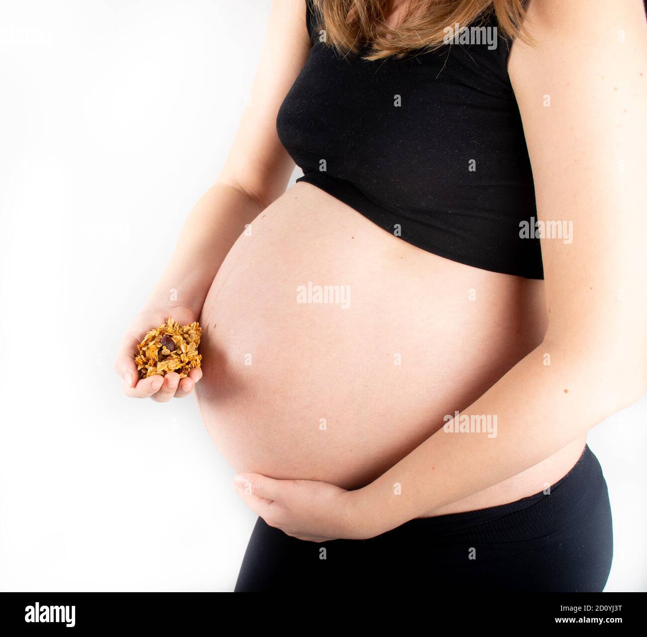 Pregnant woman holding granola or muesli in hands. Healthy eating