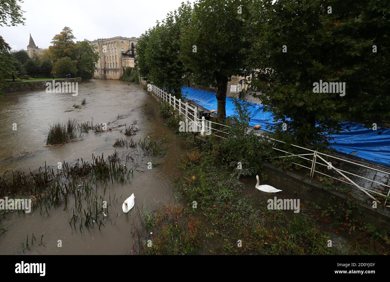 Temporary flood defenses which have been put up next to the River Avon in Bradford-on-Avon in Wiltshire. The UK's wet weekend will continue as a weather warning for rain across parts of Wales and England has been extended. Stock Photo