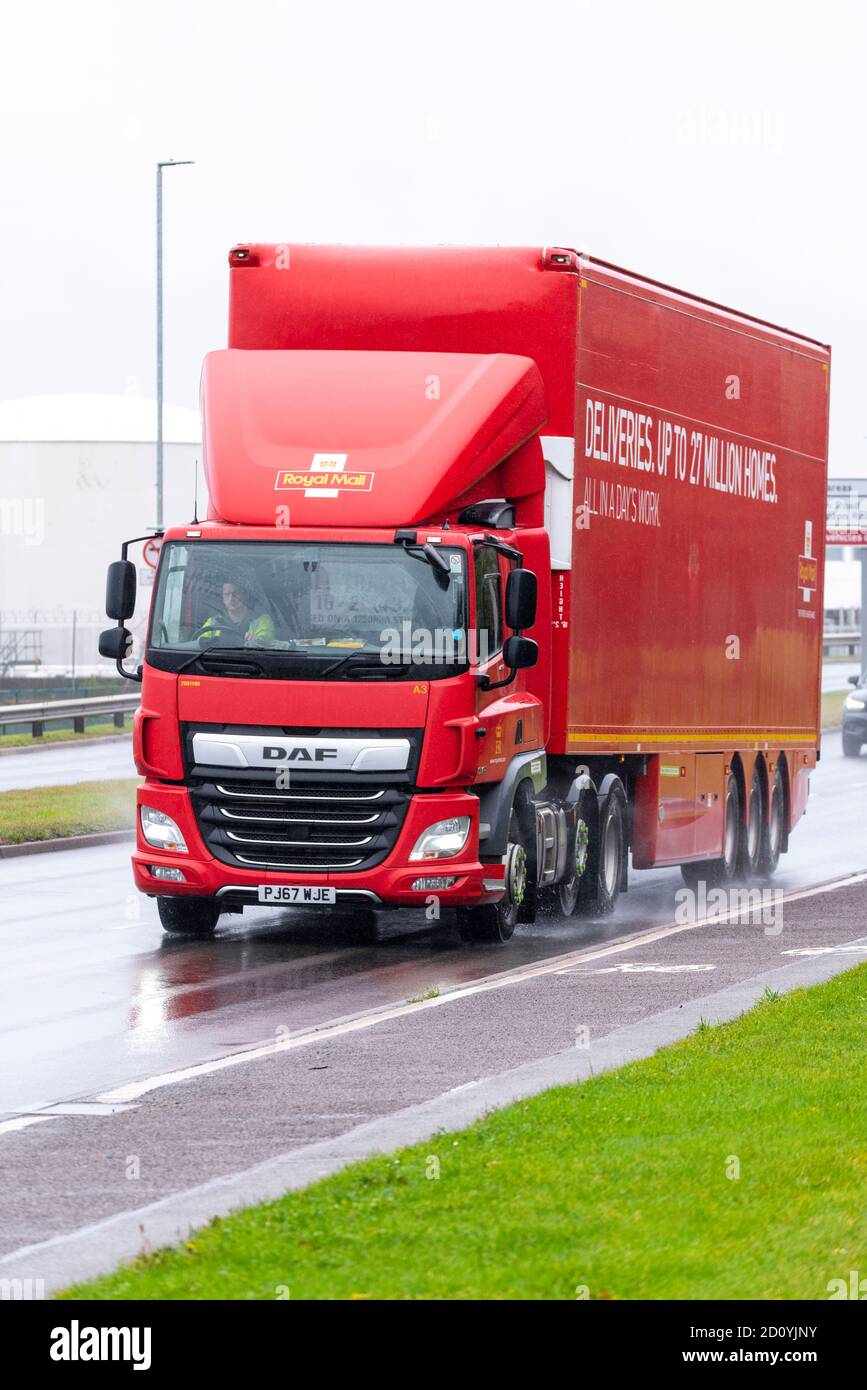 Royal Mail transport HGV, articulated lorry driving near London Heathrow Airport, UK. DAF CF cab. Truck on road in bad weather. Rain water Stock Photo