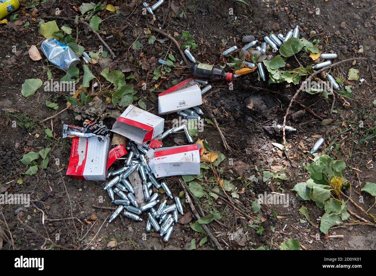 Uxbridge, Middlesex, UK. 28th September, 2020. Discarded cream chargers by the side of a road in Uxbridge. The use of Nitrous Oxide cream chargers by youths as recreational drugs often referred to as hippy crack or laughing gas, has increased substantially since the Coronavirus lockdown started. Inhalation of the Nitrous Oxide gas from cream chargers that are meant to be used for culinary purposes, can be lethal as the gas may cause a spasm and stop a person from breathing or cause nerve damage to the body. Credit: Maureen McLean/Alamy Stock Photo