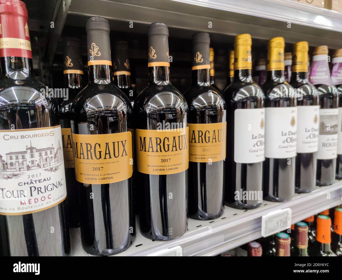 Supermarket shelves filled with many bottles and brands French wines