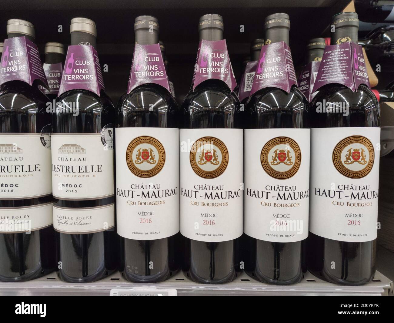 Supermarket shelves filled with many bottles and brands French wines