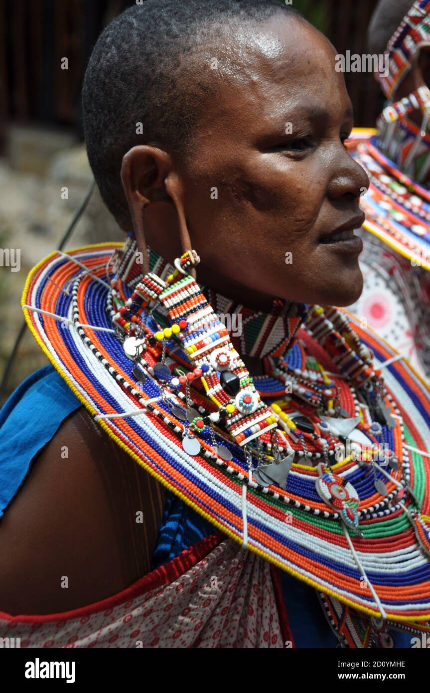 Kenya:  A beautifull Masai Women artist with tradition colour glass perls around her neck. Stock Photo