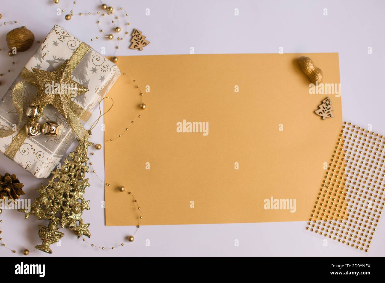 Place for an inscription. New Year's composition. golden decorations, gift, tree. Stock Photo