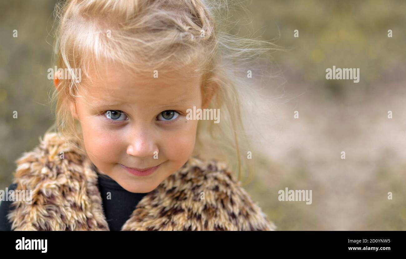 Child portrait, close-up. Girl outdoors in nature. Beautiful girl 3 years old. Autumn photo. Children's emotions. Free space for text Stock Photo