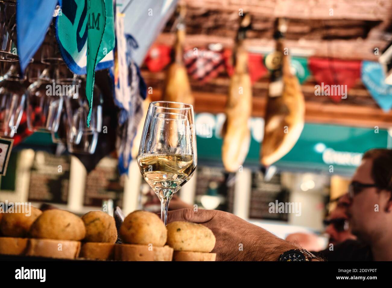 Benidorm, Alicante Province, Spain October 5, 2019, glasses with white wine and croquettes on a showcase of the tapas bar 'Cava Aragonesa' in Calle Santo Domingo in the old town Stock Photo