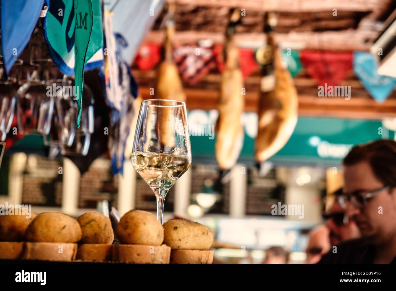 Benidorm, Alicante Province, Spain October 5, 2019, glasses with white wine and croquettes on a showcase of the tapas bar 'Cava Aragonesa' in Calle Santo Domingo in the old town Stock Photo