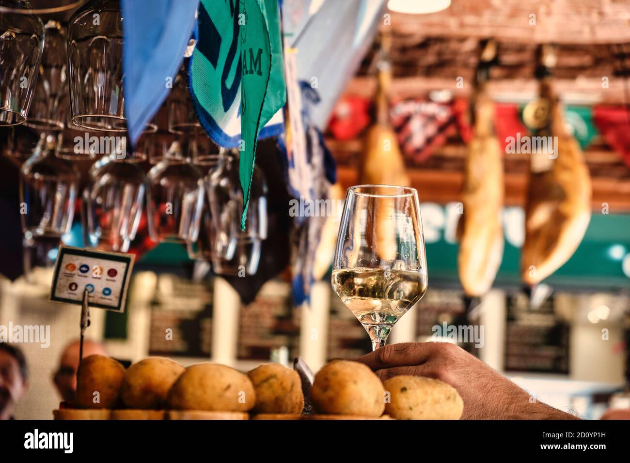 Benidorm, Alicante Province, Spain October 5, 2019, glasses with white wine and croquettes on a showcase of the tapas bar 'Cava Aragonesa' in Calle Santo Domingo in the old town Stock Photo