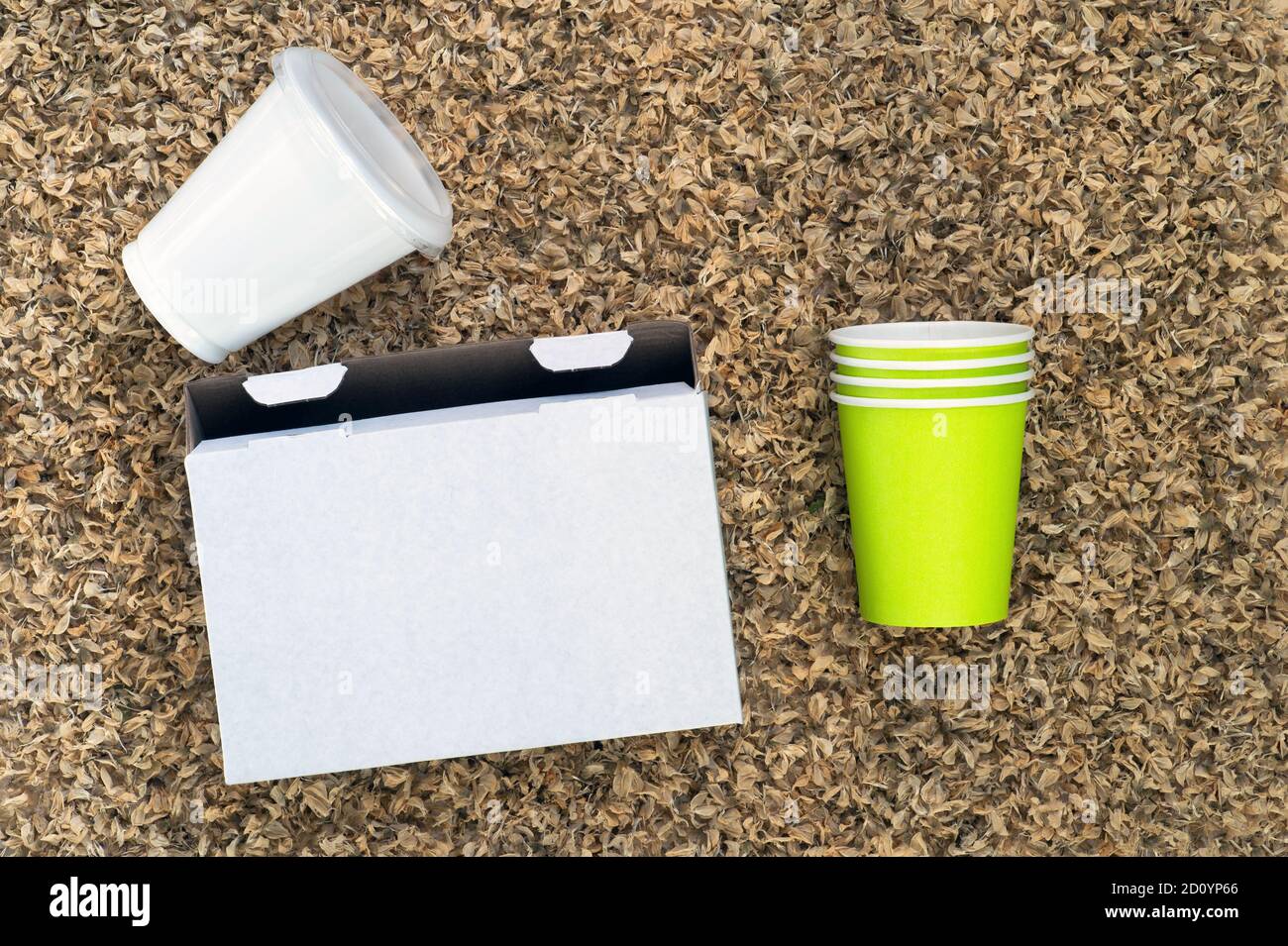 White cardboard box, plastic Cup and paper cups on the background of