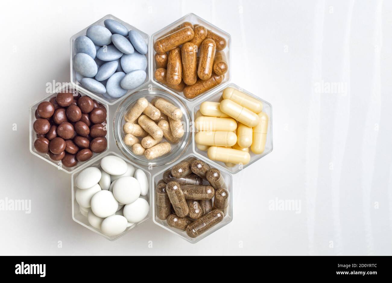 Various medical capsules and tablets in hexagonal jars in the form of ...