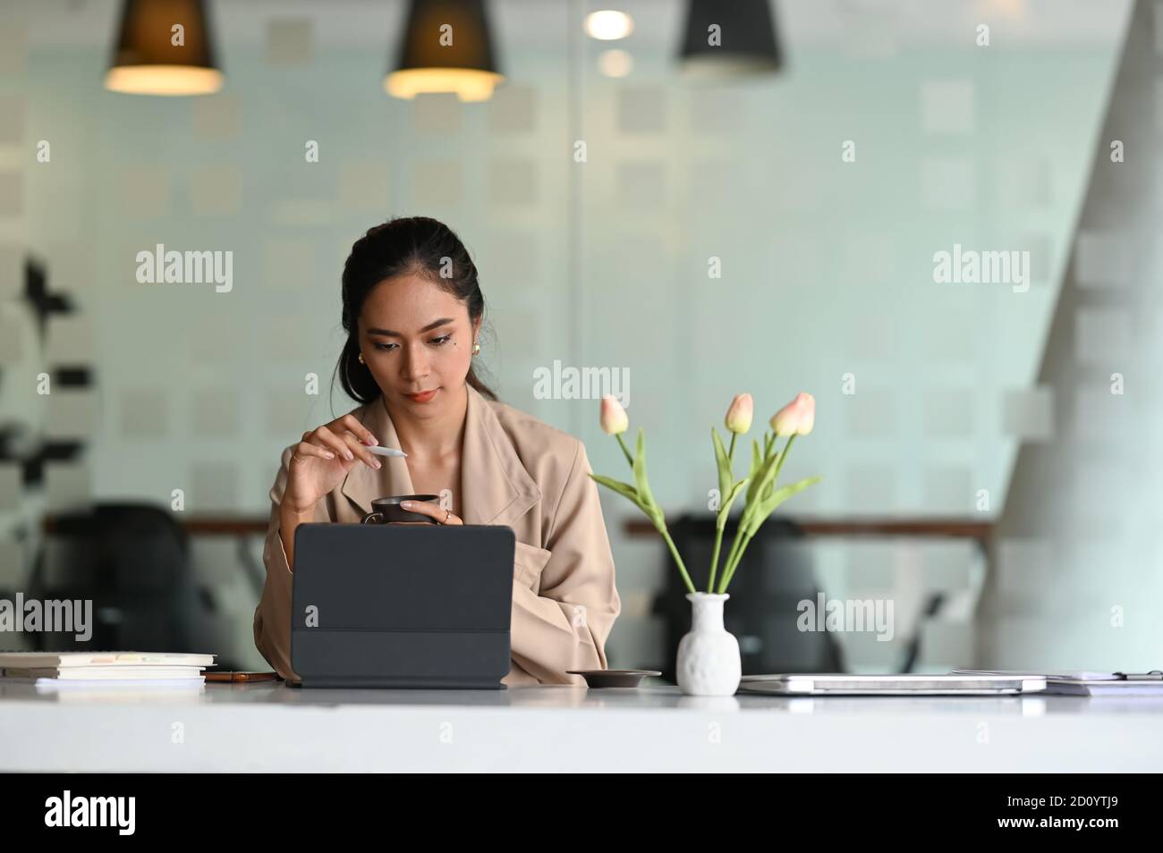 Young attractive businesswoman searching the data on internet with ...