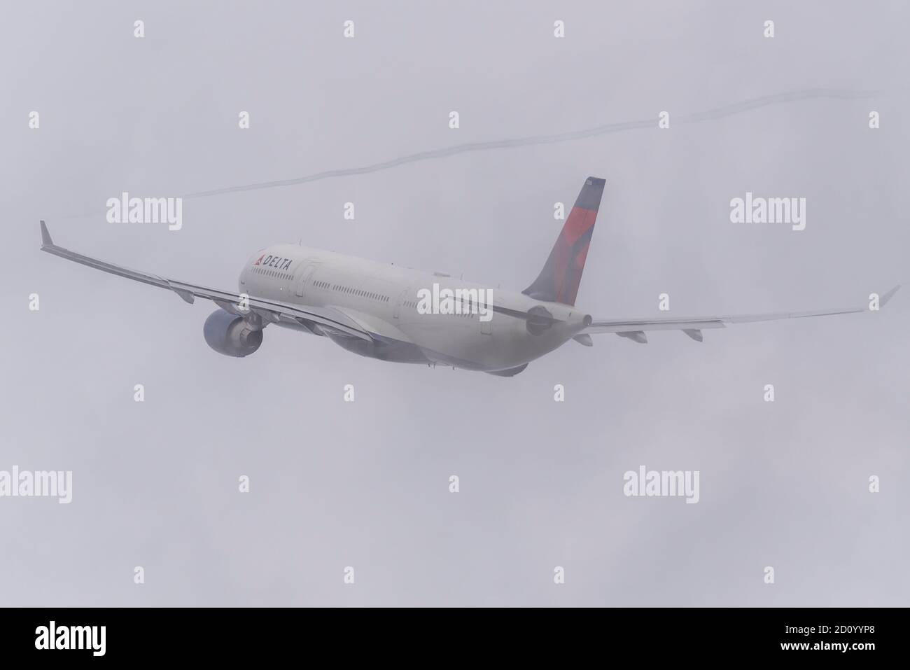 Delta Air Lines Airbus A330 -300 jet airliner plane N808NW taking off in bad weather from London Heathrow Airport, UK. Flying into heavy cloud Stock Photo