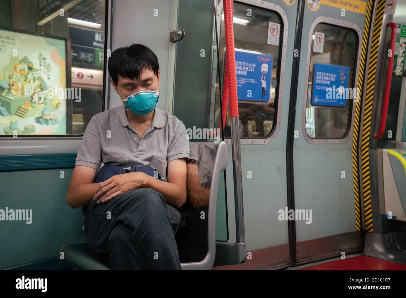 A man weaning a surgical mask in the public transport in Hong Kong. The