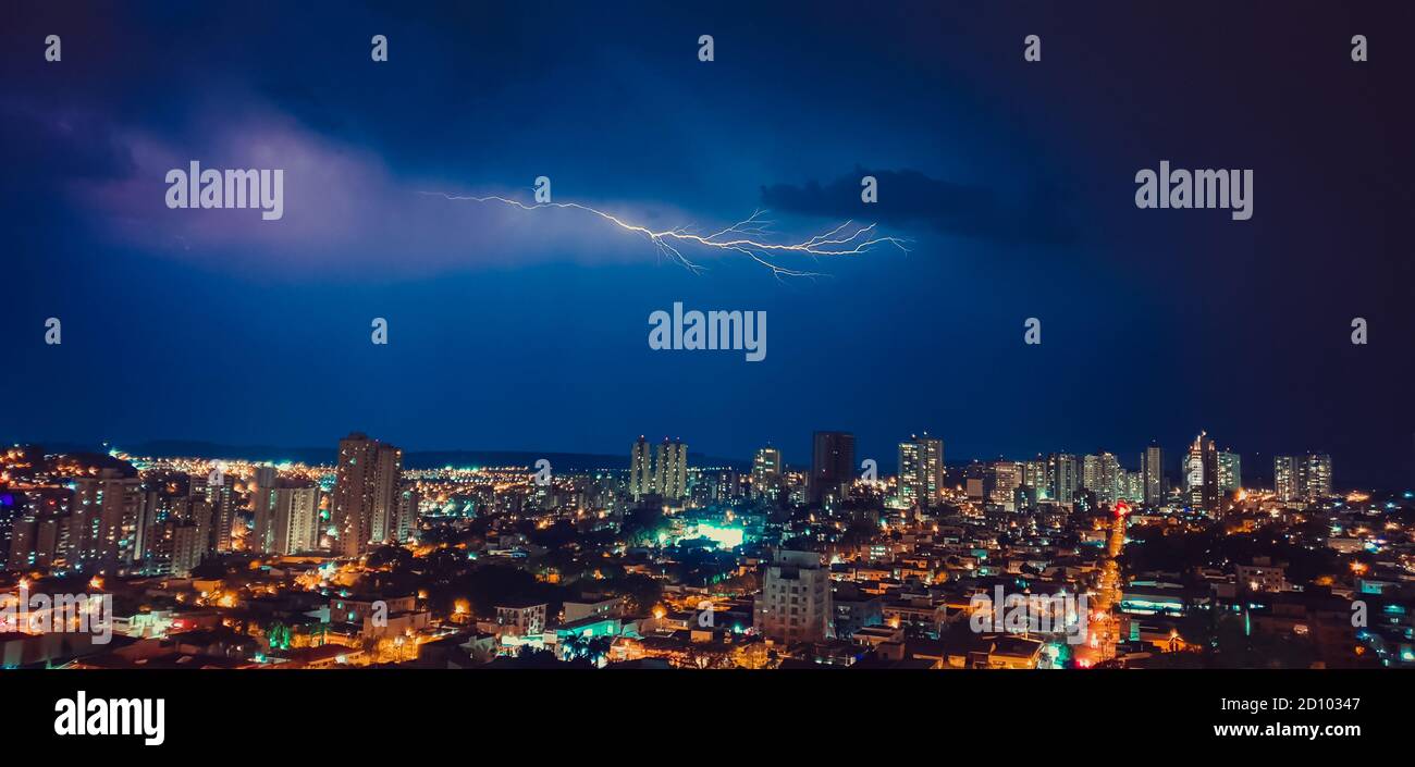 Dark sky and thunder rays in the city skyline Stock Photo