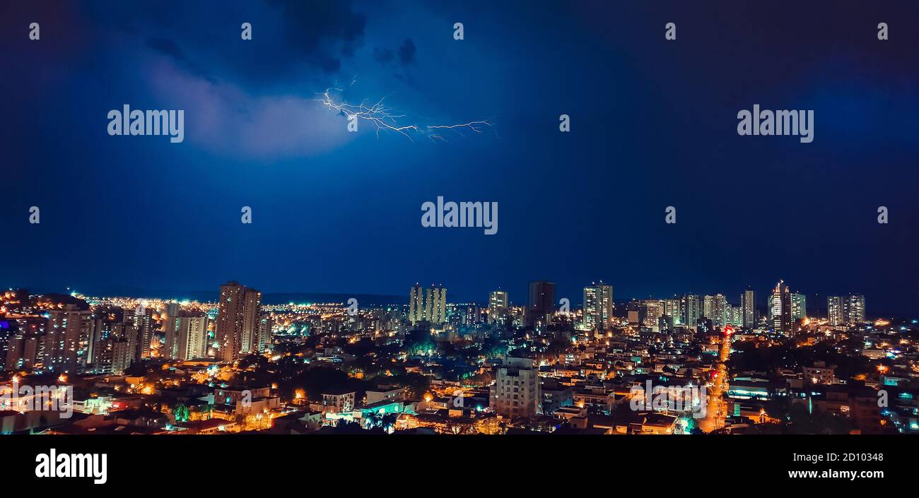 Dark sky and thunder rays in the city skyline Stock Photo