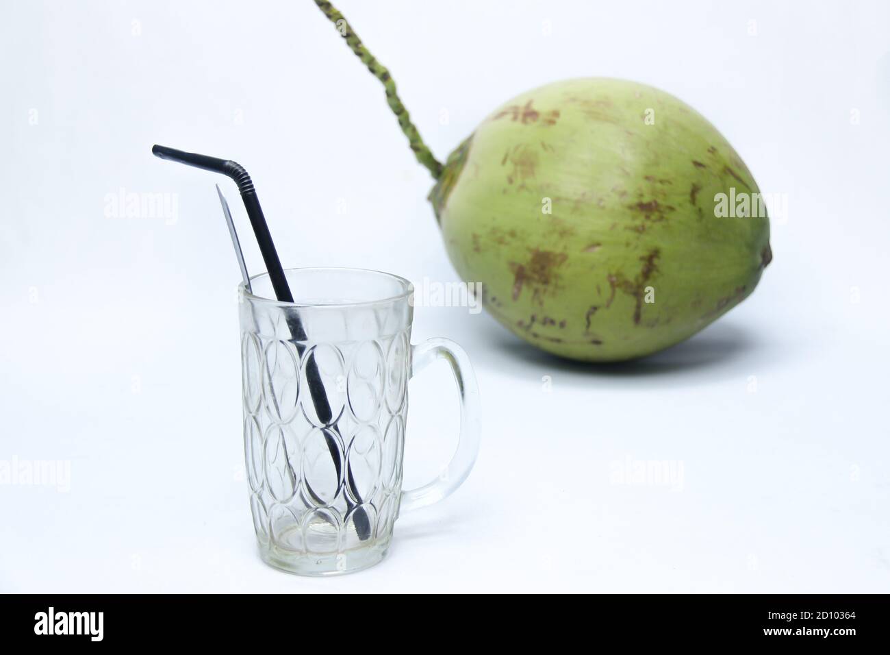 empty glass with green coconut isolated on white background. natural fresh drink Stock Photo