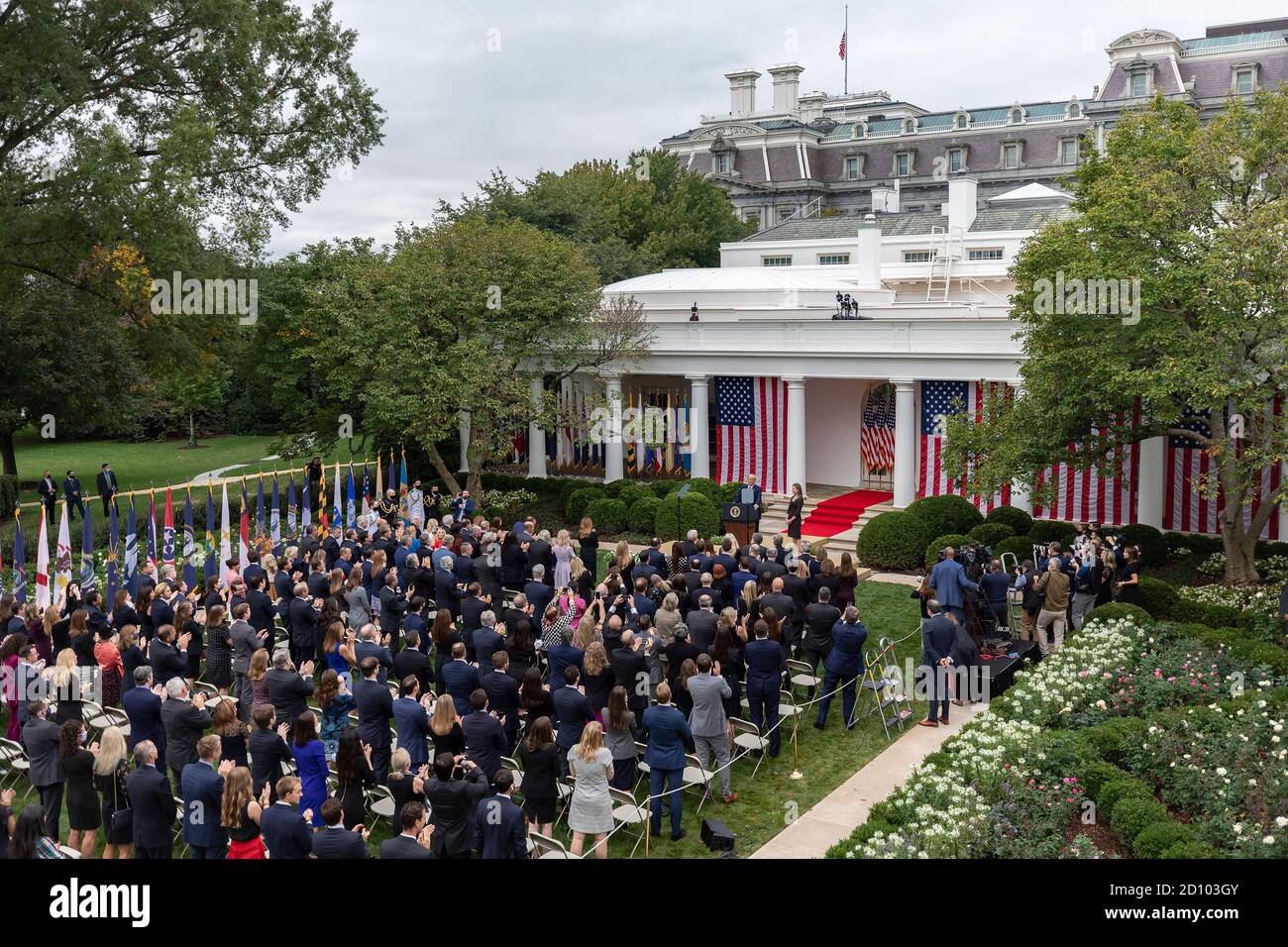 President Trump Nominates Judge Amy Coney Barrett for Associate Justice of the U.S. Supreme Court. This is the event that some believe is a  super spreader gathering where the president acquired or  spread COVID 19 to multiple attendees. President Donald J. Trump listens as Judge Amy Coney Barrett, his nominee for Associate Justice of the Supreme Court of the United States, addresses her remarks Saturday, September 26, 2020, in the Rose Garden of the White House. Stock Photo