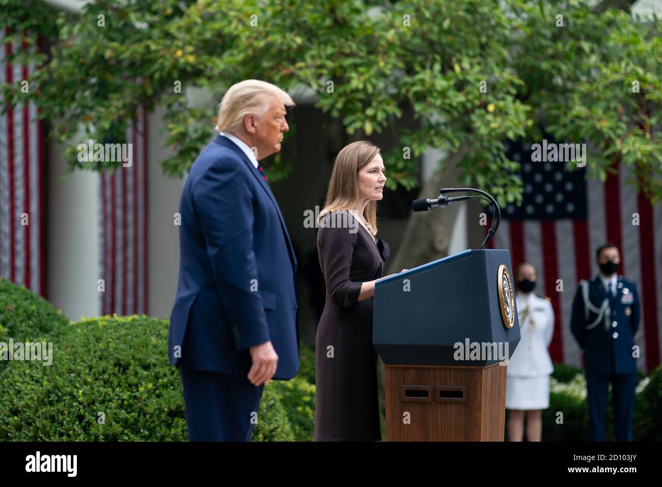 President Trump Nominates Judge Amy Coney Barrett for Associate Justice of the U.S. Supreme Court. This is the event that some believe is a  super spreader gathering where the president acquired or  spread COVID 19 to multiple attendees. President Donald J. Trump listens as Judge Amy Coney Barrett, his nominee for Associate Justice of the Supreme Court of the United States, addresses her remarks Saturday, September 26, 2020, in the Rose Garden of the White House. Stock Photo
