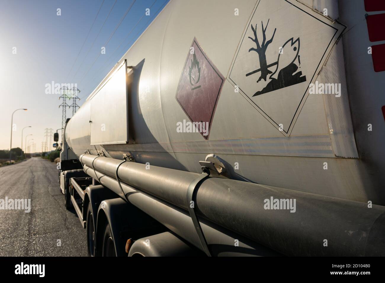 Danger labels on a tank truck carrying fuel and traveling on a highway. Stock Photo