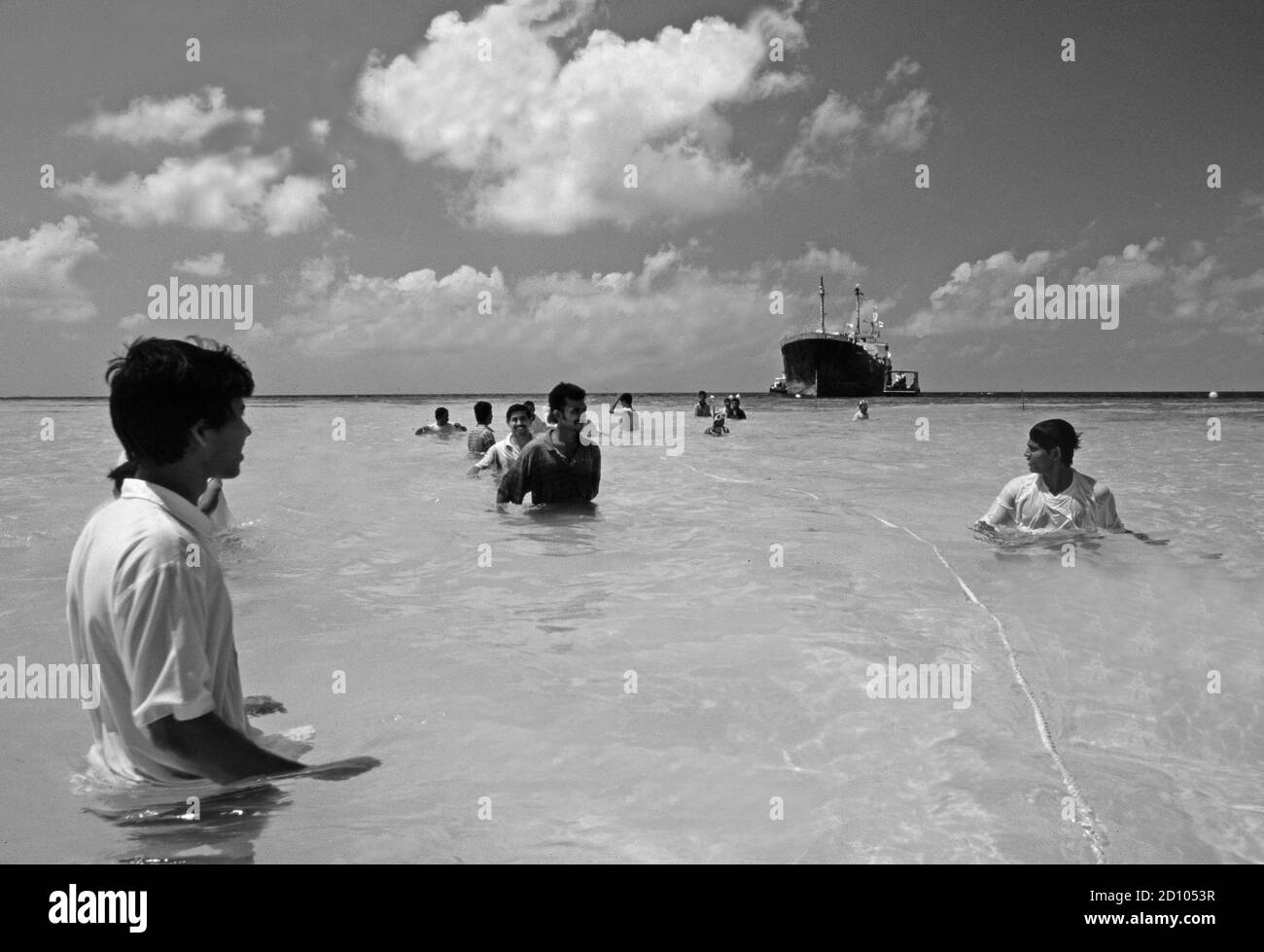 Maledives: Local people pulling a old freight ship to the coast to sink it and cultivate a coral reef Stock Photo