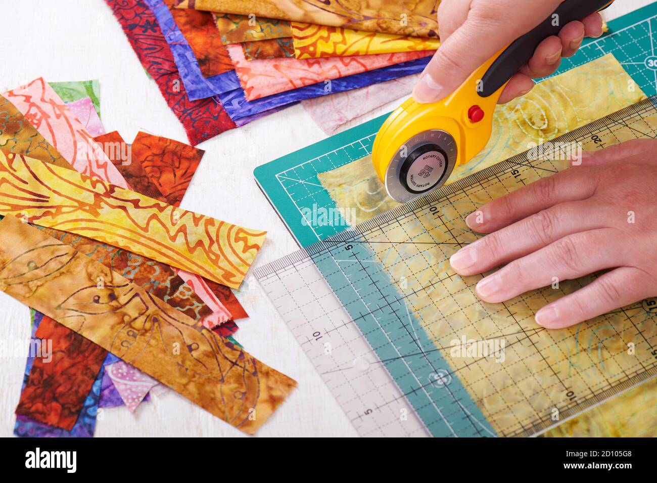 Process cutting fabric pieces by rotary cutter on mat using ruler Stock