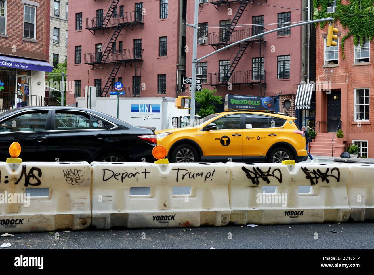 NEW YORK, USA - MAY 10, 2019: Graffiti bearing the slogan - Deport Trump! - on a traffic barrier on 7th Avenue, New York City on May 10, 2019. Traffic Stock Photo