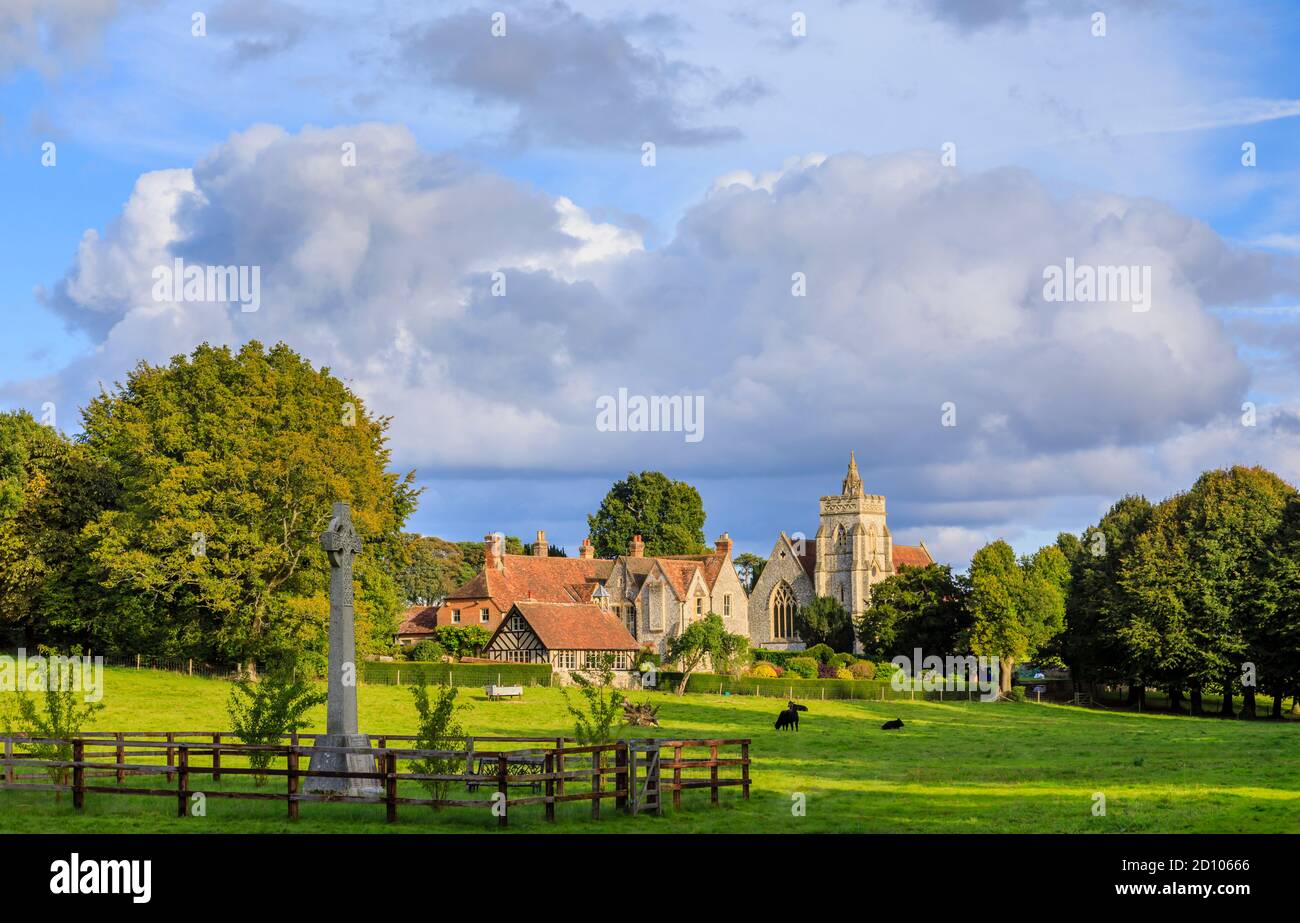 Christ Church and an adjacent large flint-faced country house in Fosbury village, Wiltshire in the parish of Fosbury and Tidcombe, in afternoon light Stock Photo