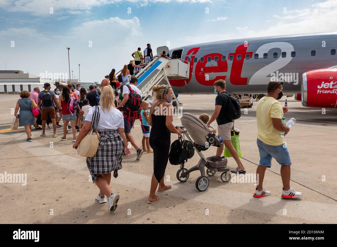 Picture dated August 1st 2020 shows Jet2 passengers boarding a plane back to London Stansted  at Ibiza  Airport on Saturday morning.Some passengers had to return home early after the company cancelled return flights.   Jet2 has contacted some customers on Spain's Balearic and Canary Islands to ask them to end their package holidays early. Hundreds of customers have had flights back to the UK cancelled and been asked to return sooner than planned.  Jet2 said it cannot keep sending empty planes to pick up passengers on many different dates.   Travellers were informed of the changes via emails an Stock Photo