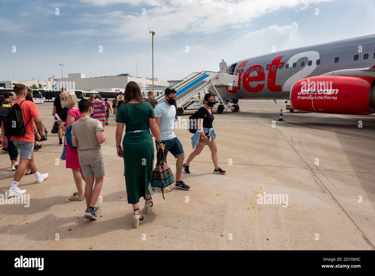 Picture dated August 1st 2020 shows Jet2 passengers boarding a plane back to London Stansted  at Ibiza  Airport on Saturday morning.Some passengers had to return home early after the company cancelled return flights.   Jet2 has contacted some customers on Spain's Balearic and Canary Islands to ask them to end their package holidays early. Hundreds of customers have had flights back to the UK cancelled and been asked to return sooner than planned.  Jet2 said it cannot keep sending empty planes to pick up passengers on many different dates.   Travellers were informed of the changes via emails an Stock Photo