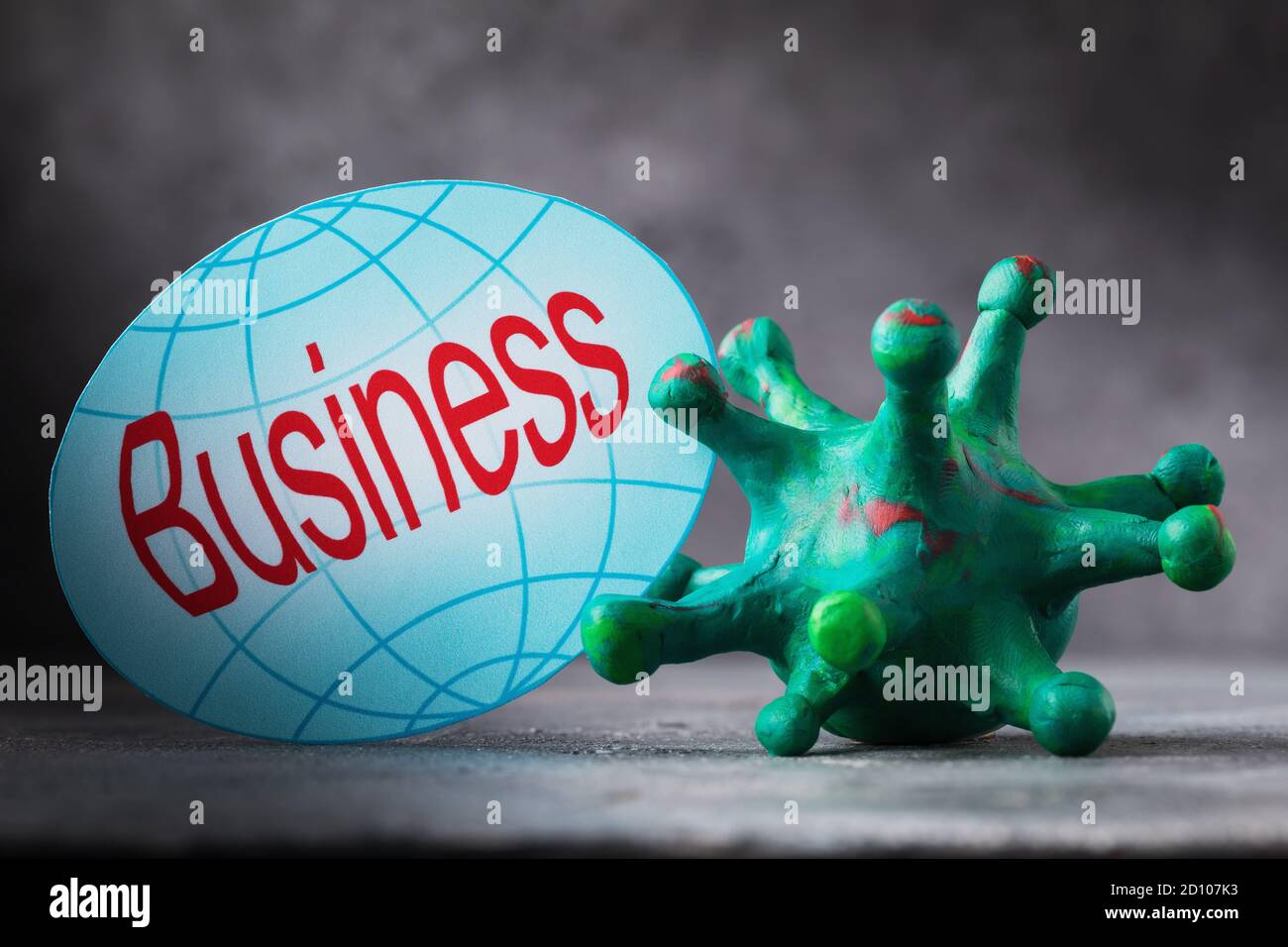 Paper tag with text and mock-up of bacteria from plasticine. Concept on the impact of coronavirus on business in the world Stock Photo