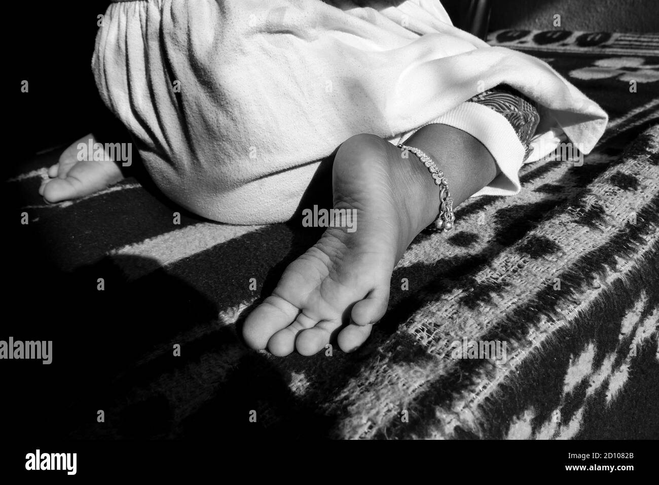 a close view of Indian girl child W sitting position in black & white photo Stock Photo