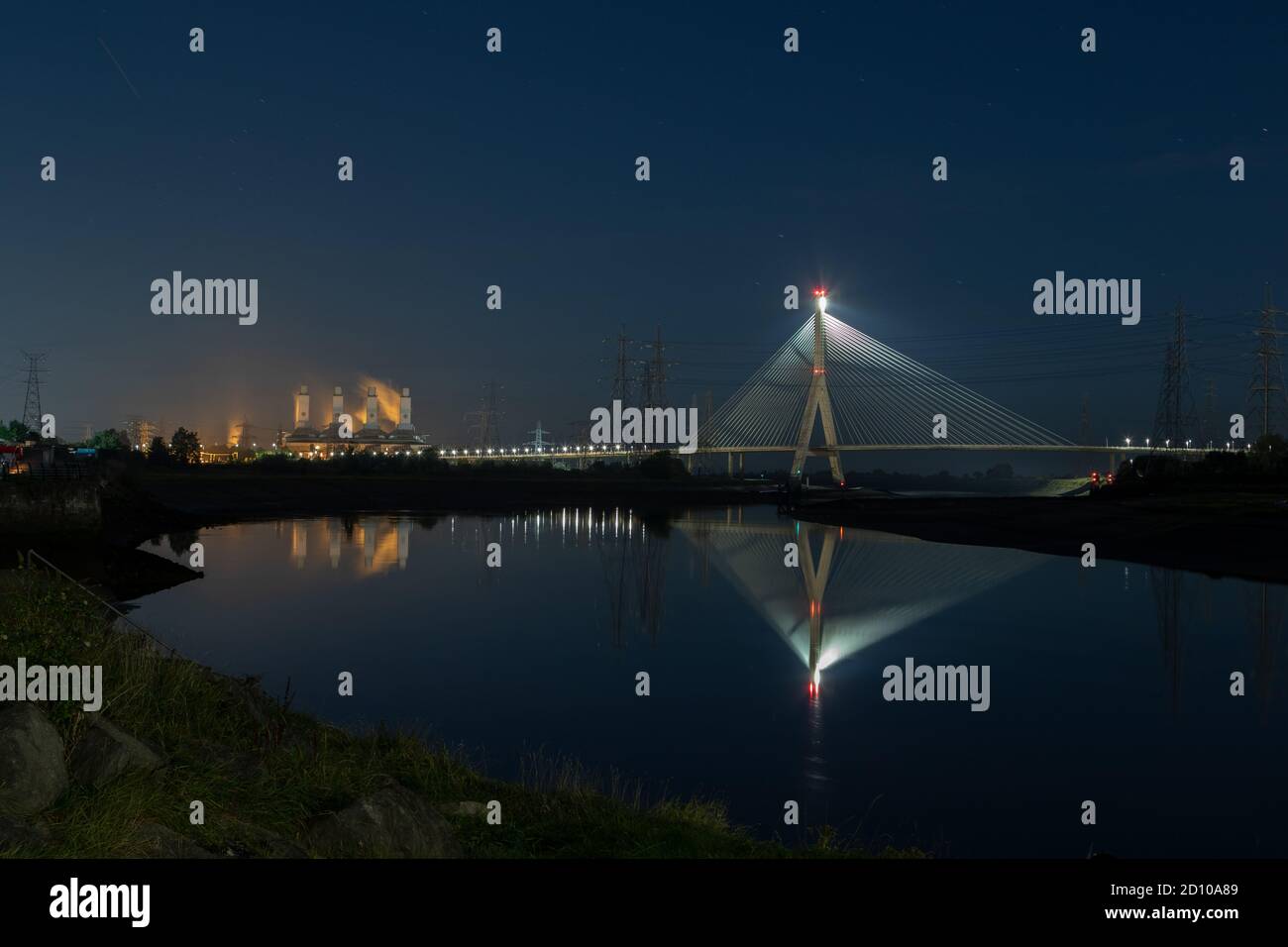 Cable-stayed Flintshire Bridge,lit at night, spanning River Dee linking Flint and Wirral Peninsula. Connah's Quay Gas Power Station to the South West Stock Photo