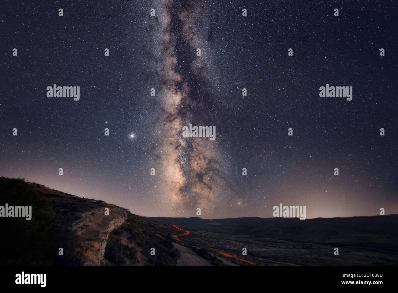 The Milky Way with car light trails on the Foreground Landscape Stock ...